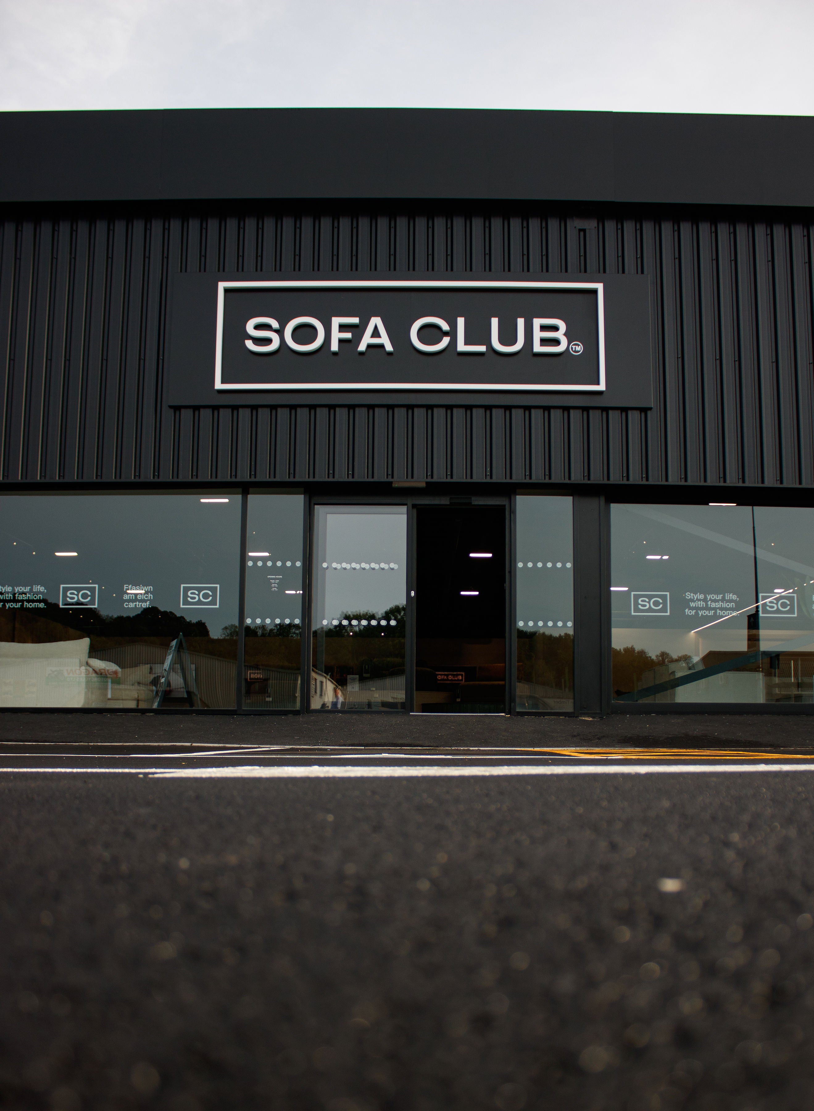 Portrait exterior view of the Sofa Club Cardiff showroom sign and entrance